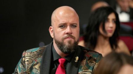Chris Sullivan poses at an event in his stylish suit.